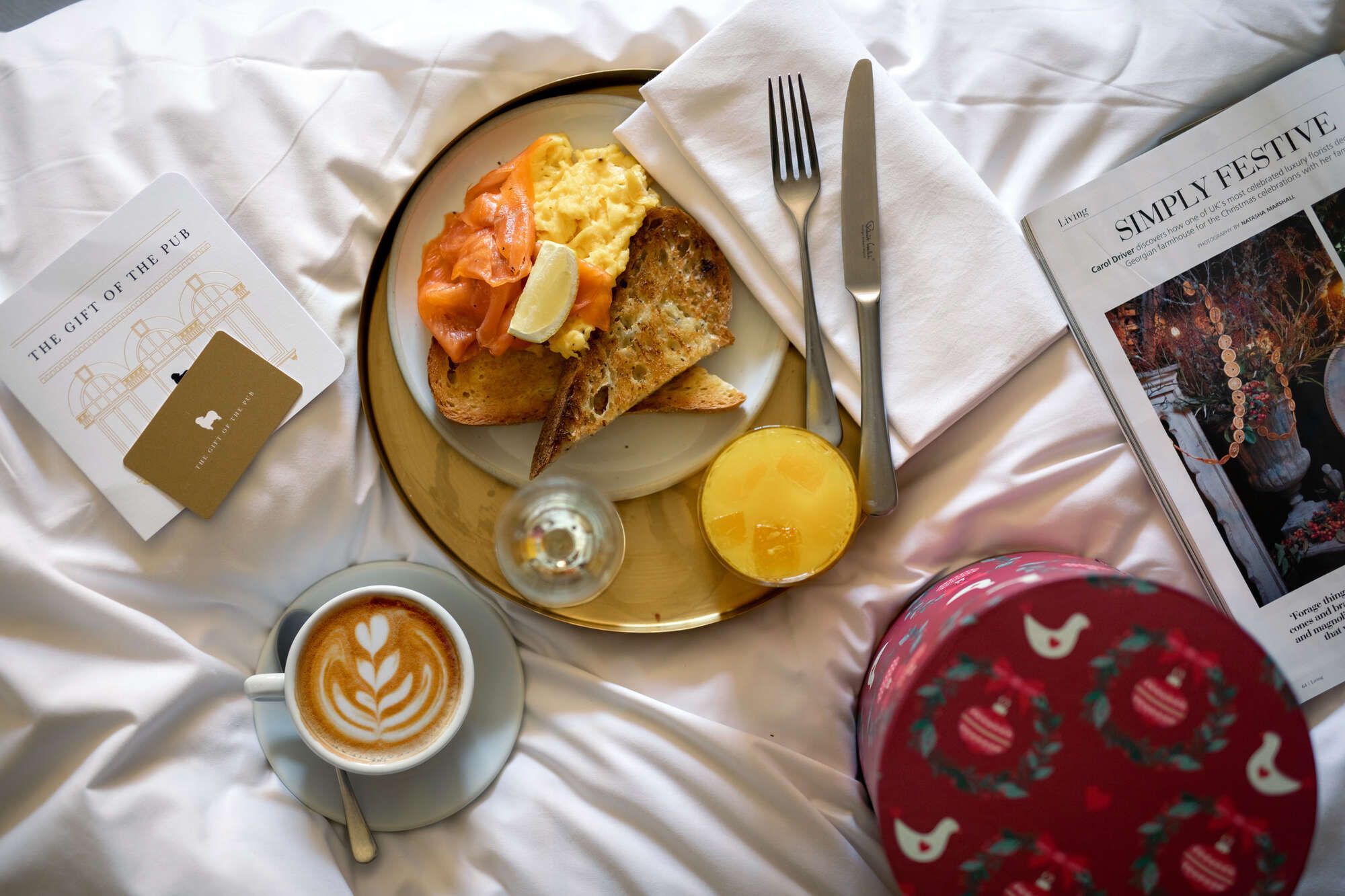 breakfast in bed with smoked salmon, eggs, toast, and coffee next to a Young's gift card