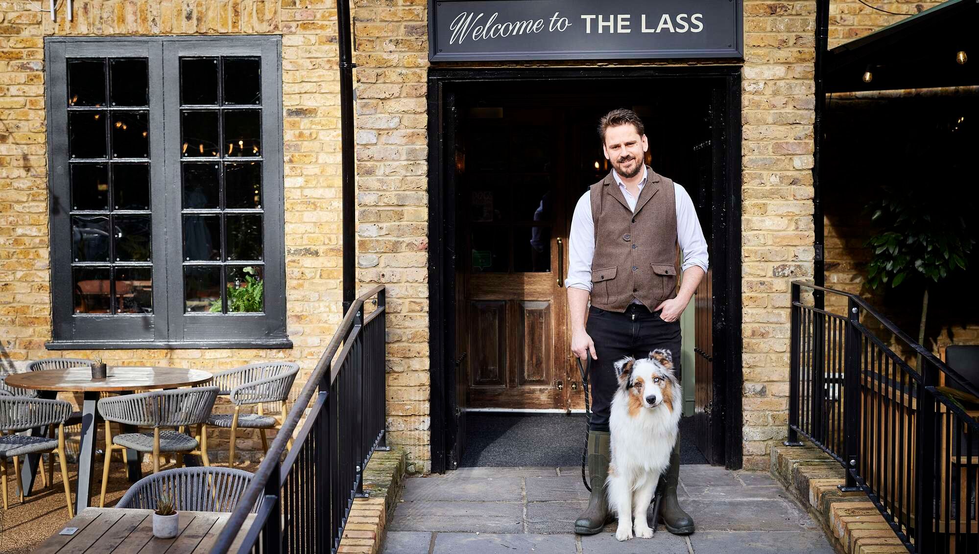 Landlord Chris and his dog outside the Lass O'Richmond Hill pub