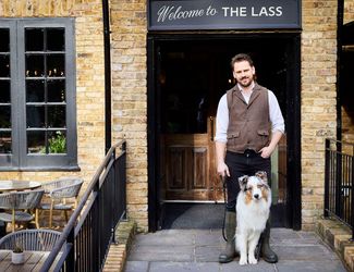 Landlord Chris and his dog outside the Lass O'Richmond Hill pub