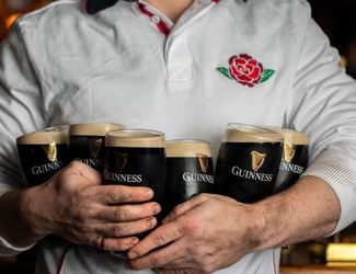 Hold a round of Guinness wearing an England jersey