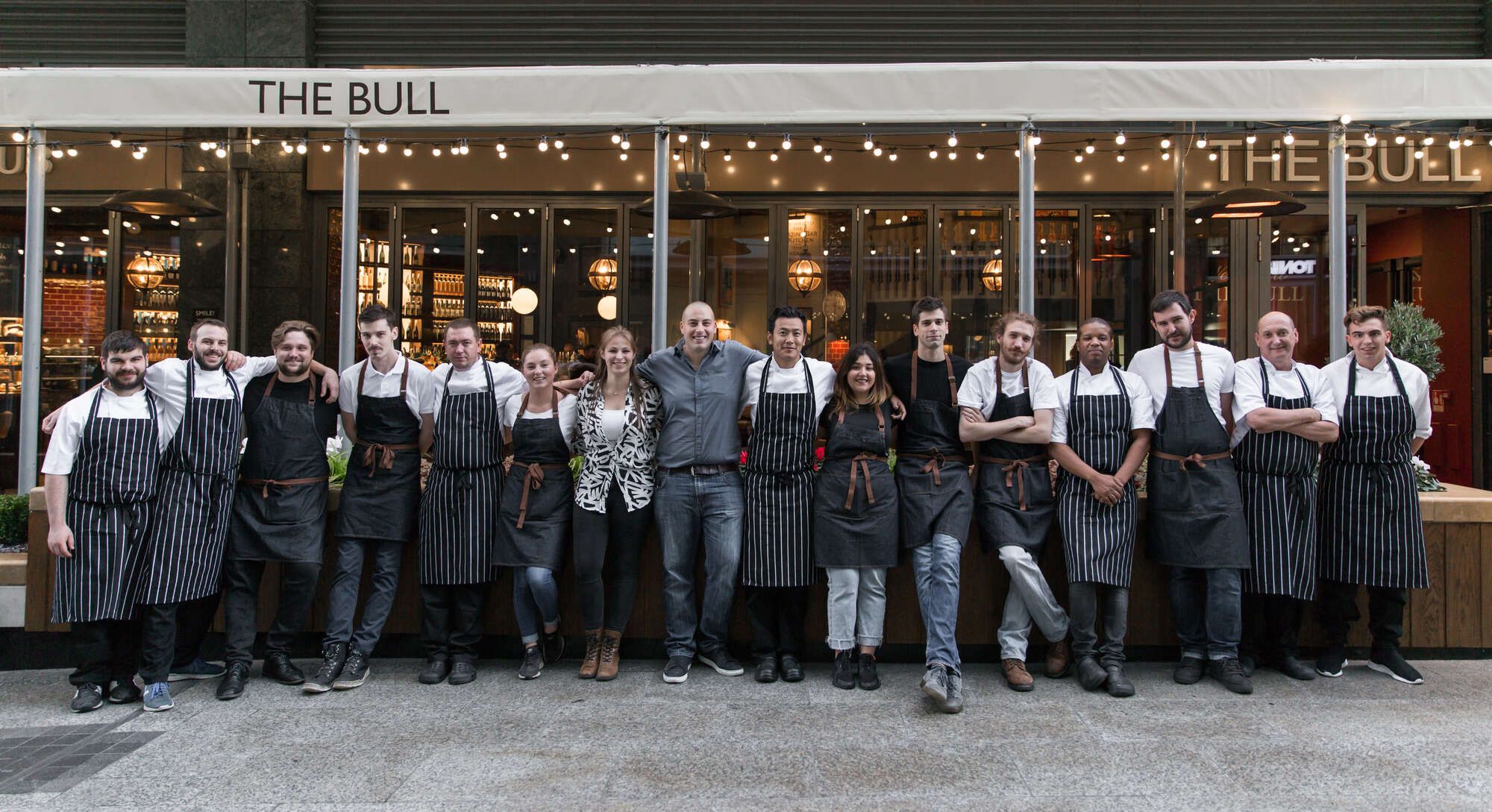 The team of the bull stood outside the pub