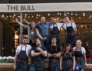 The team of the bull stood outside the pub