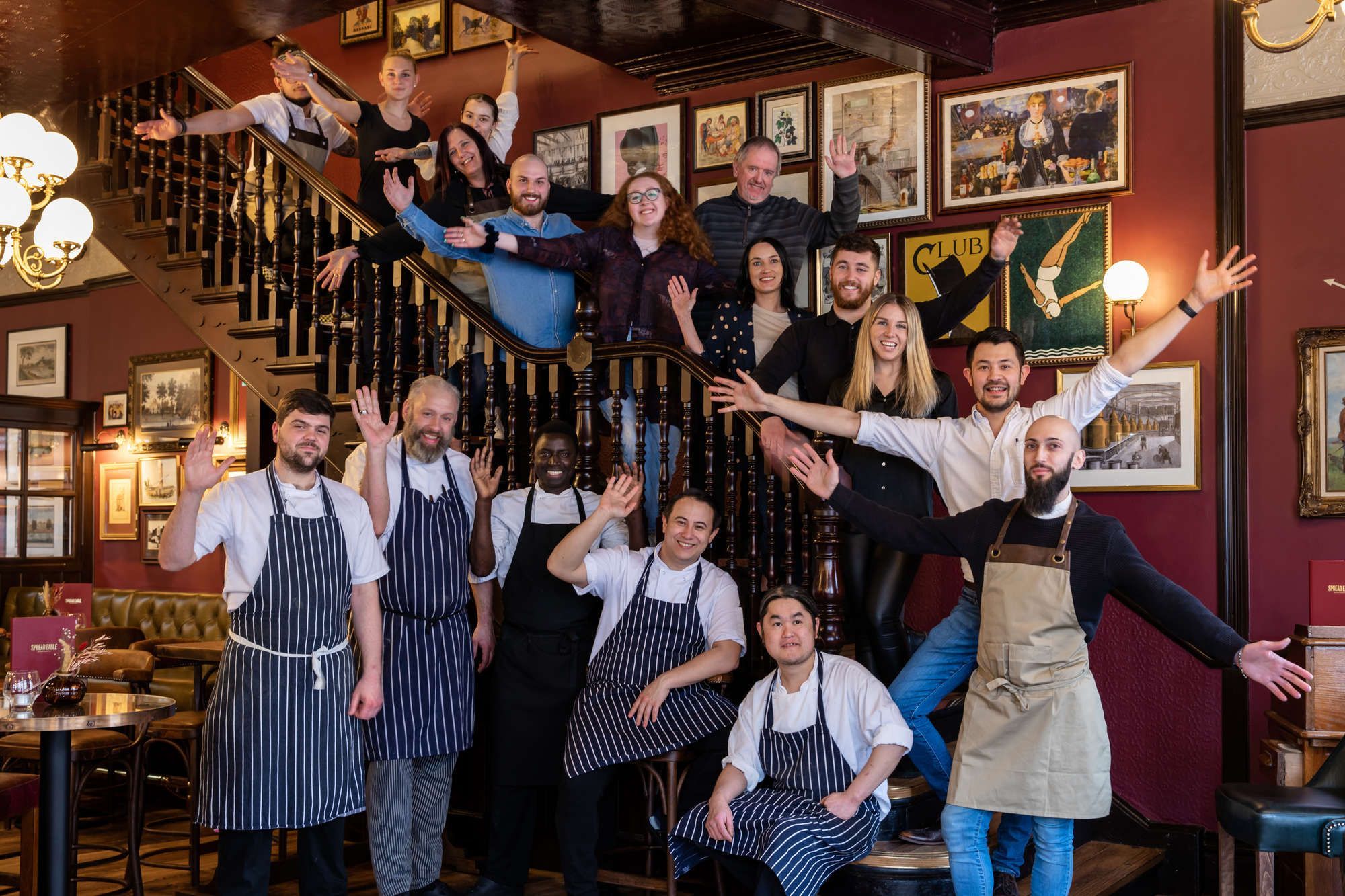 large group of Young's staff standing on a staircase in a Young's pub