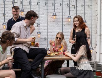 Friends in a pub garden enjoying a few drinks