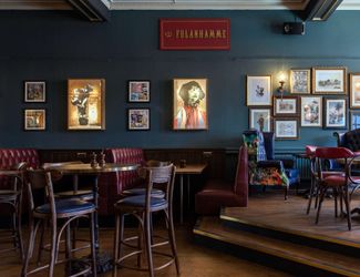 Tables and chairs inside the Cock Tavern