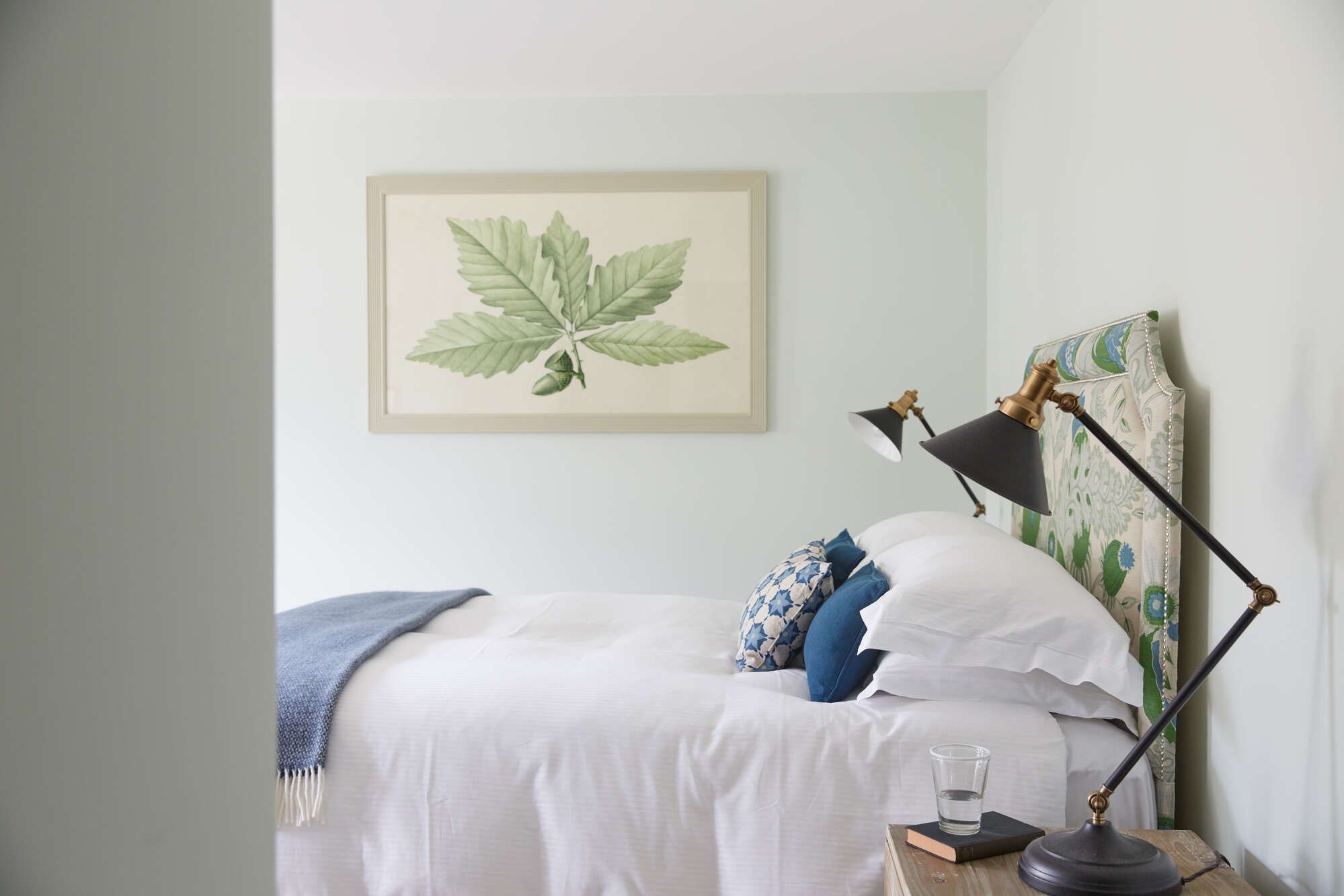 bedroom with botanical print and blue accents