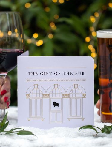 Young's gift voucher on a table with pinecones, wine and a Young's pint