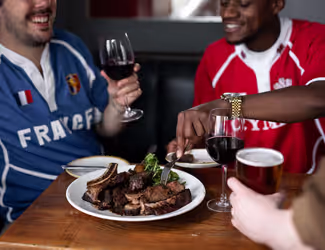group of friends sharing a meal and wine