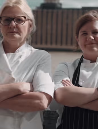Natalie Coleman and another chef standing side by side with their arms crossed